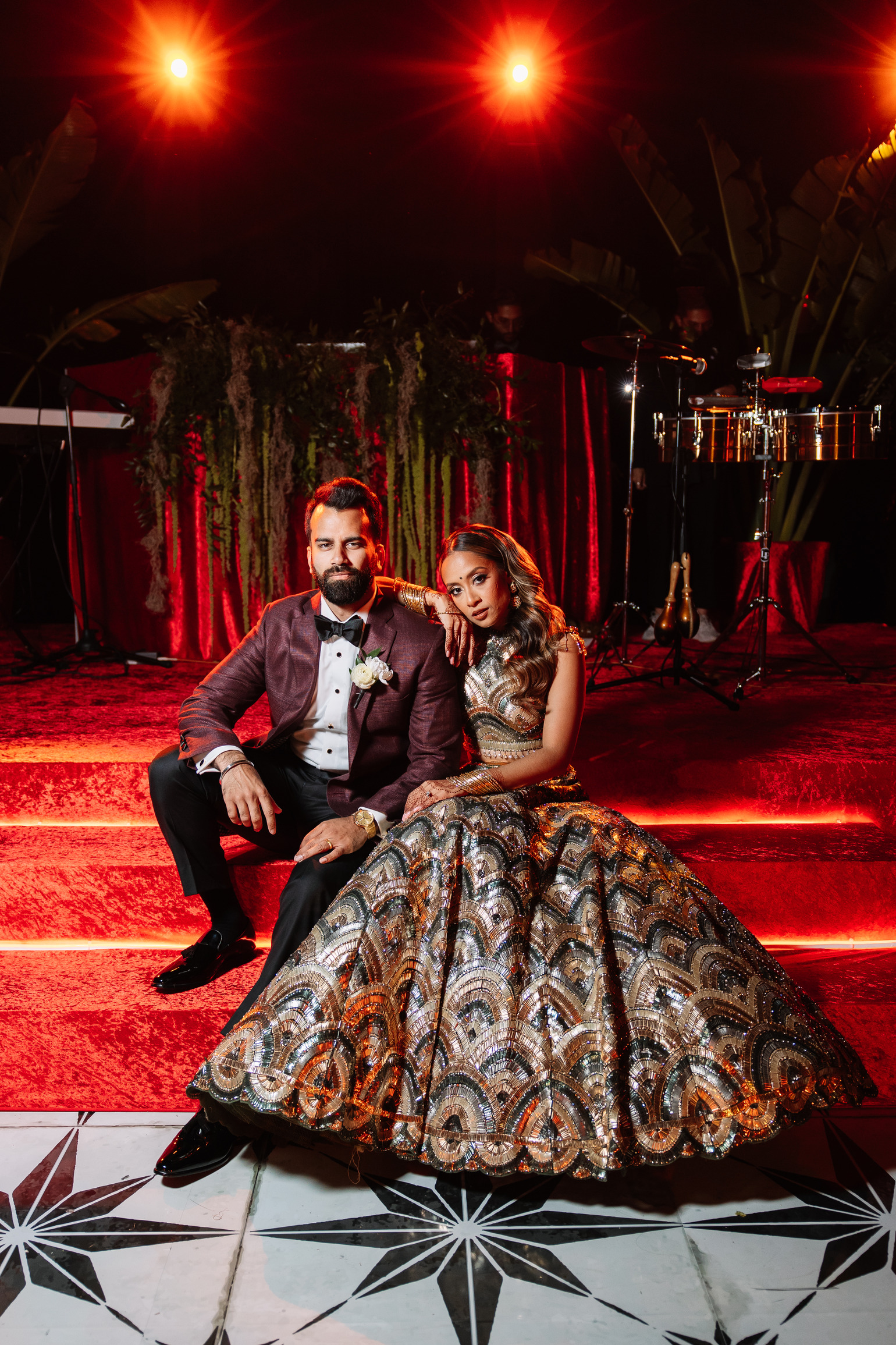 Bride and Groom sitting on Red Velvet Reception Stage