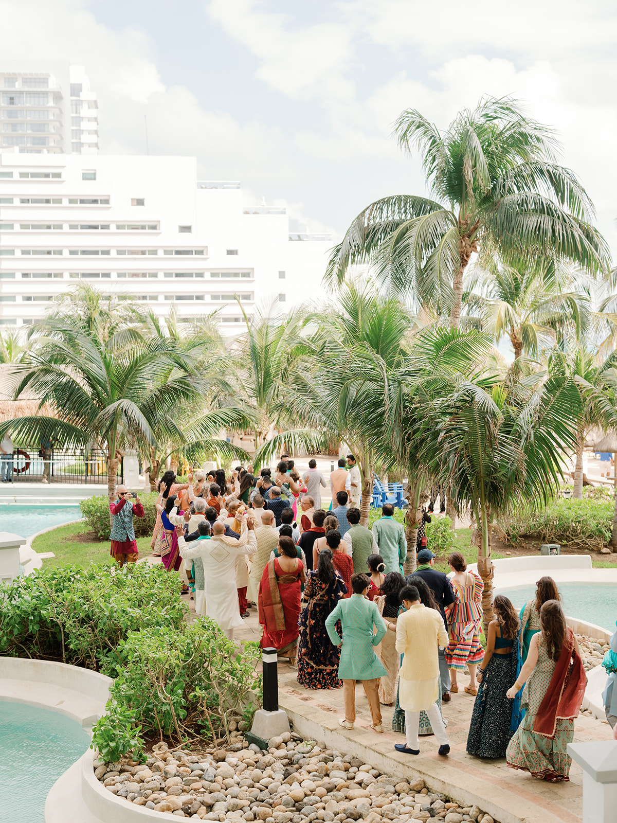 Baraat celebration at JW Marriott Cancun Mexico with all guests in colorful traditional Indian attire.